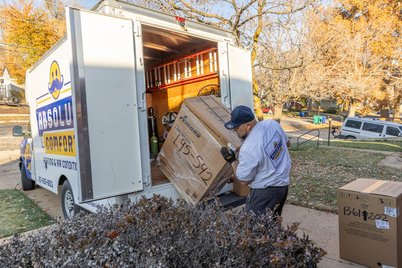 An Absolute Comfort expert hvac unloading an hvac system from a truck.
